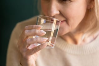 Woman drinking a glass of water.