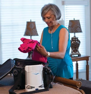 Woman packing clothes with the Freestyle Comfort.