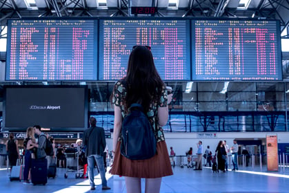 Woman checking flight time in an airport.