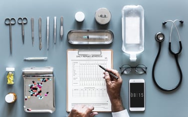 Table with doctor's tools and clipboard.