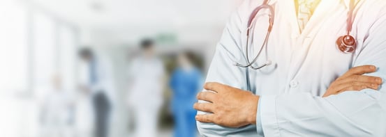 Doctor posing with stethoscope and arms crossed.