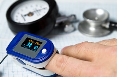 Pulse oximeter device on a finger.