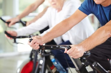 Seniors on stationary bikes.