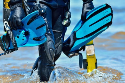 Carrying diving equipment onto the beach.