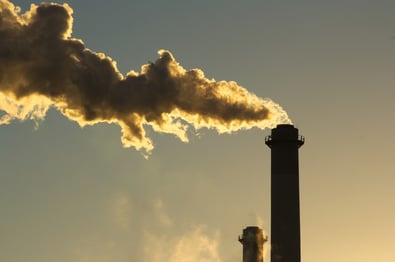 Smoke stacks coming out of a factory.