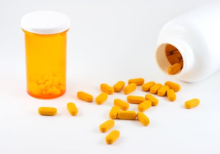 Orange medication and medication container.