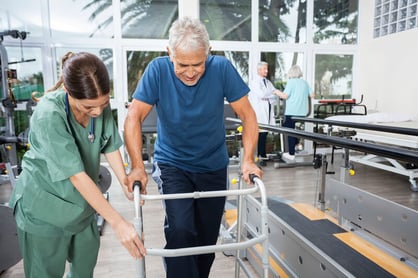 Woman helping man with pulmonary rehabilitation.