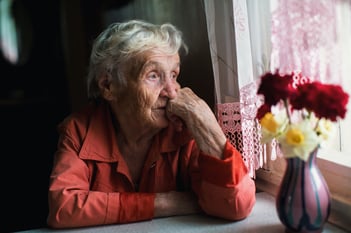 Woman sitting looking out the window.