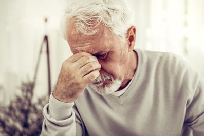 Sick man holding his nose.