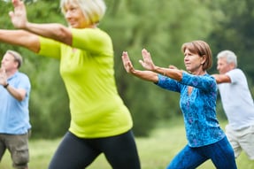 Men and women practicing Tai Chi.