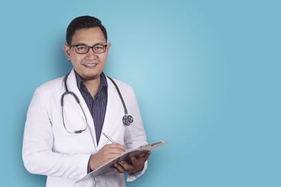 Doctor writing on a clipboard.