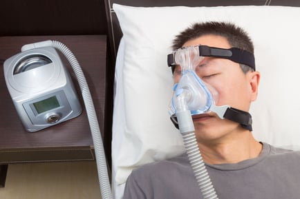 Man sleeping with CPAP machine