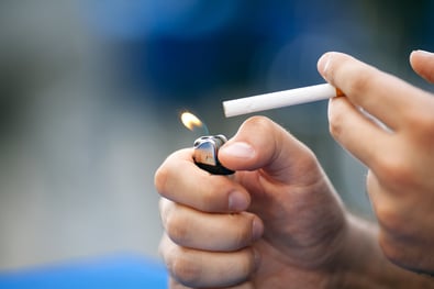 Man lighting a cigarette.