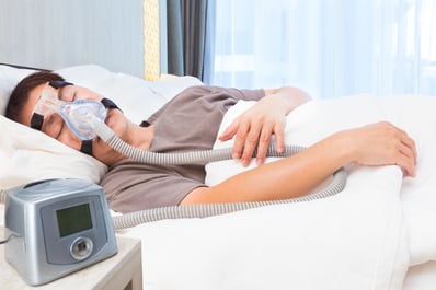 Man sleeping with CPAP machine