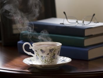 Table with books and tea on it