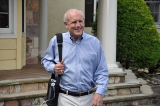 Man walking with a portable oxygen concentrator.