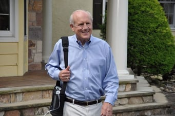 Man walking with portable oxygen concentrator.