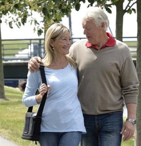 Woman with G3 walking with her husband.