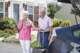 Man and woman with a portable oxygen concentrator.