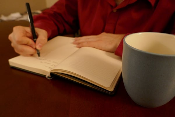 Man writing in a journal.