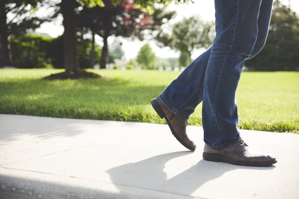 Man walking down a sidewalk.