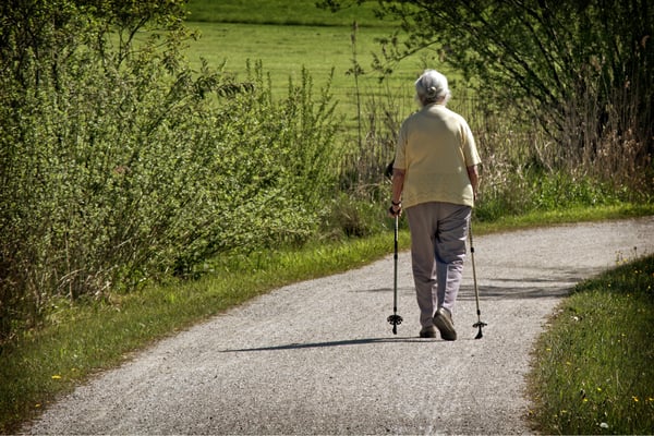 Woman hiking down a path.