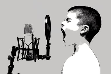 Boy singing into a microphone.