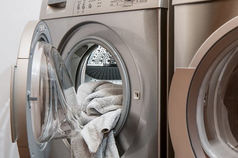 Washing machine with towels in it.